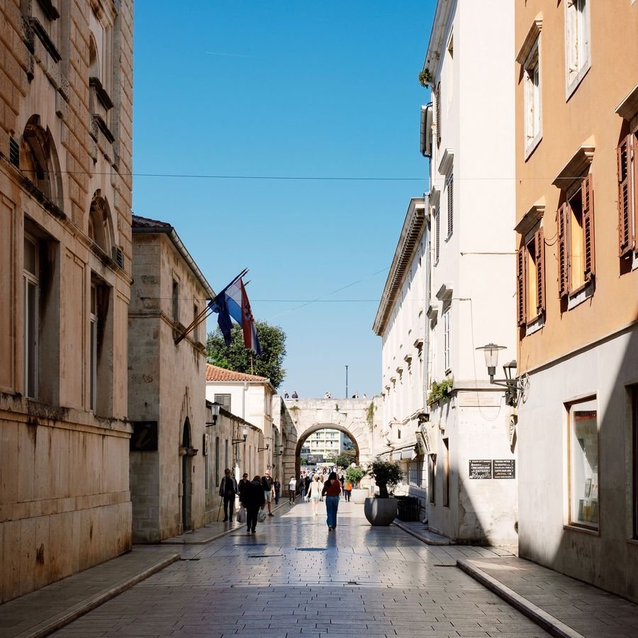 A narrow polished limestone street inside Zadar's walled old town